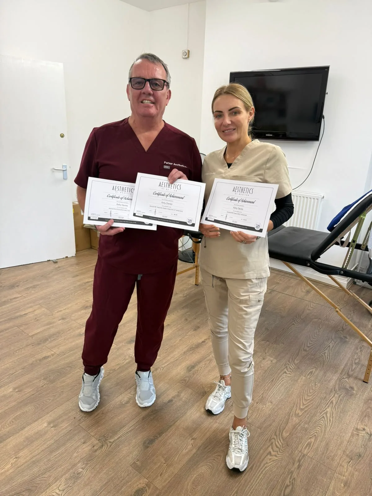 Kelly Davies completing advanced aesthetics training and holding certificates